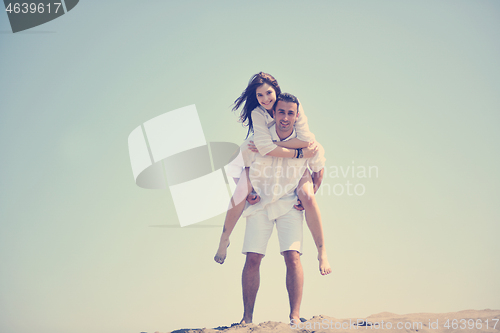 Image of happy young couple have fun on beach