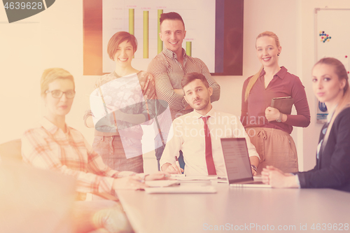 Image of startup business team on meeting at modern office with sunset in