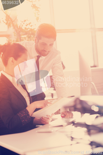 Image of business couple working together on project, sunrise in backgrou