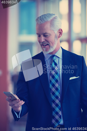 Image of senior business man talk on mobile phone