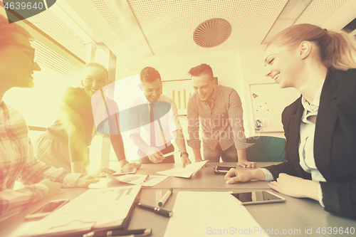 Image of startup business team on meeting at modern office with sunset in