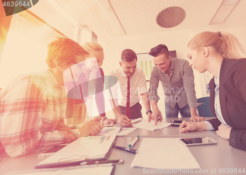 Image of startup business team on meeting at modern office with sunset in