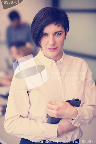 Image of hispanic businesswoman with tablet at meeting room