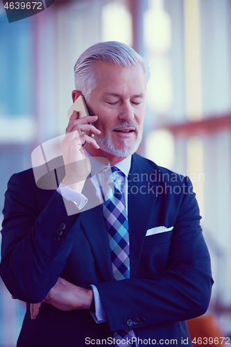 Image of senior business man talk on mobile phone