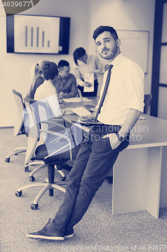 Image of young business man with tablet at office meeting room