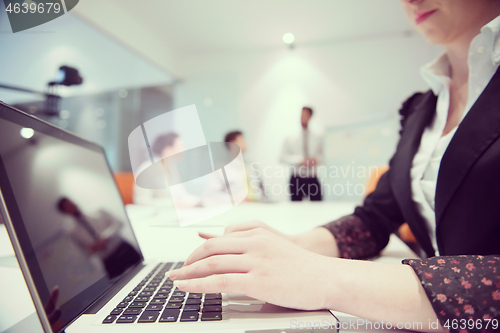 Image of woman hands typing on laptop keyboard at business meeting