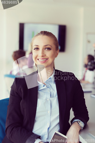 Image of portrait of young business woman at office with team on meeting 