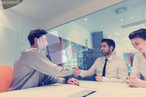 Image of young couple signing contract documents on partners back