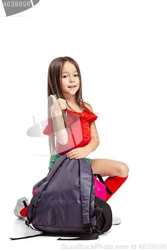 Image of Full length portrait of cute little kid in stylish jeans clothes looking at camera and smiling