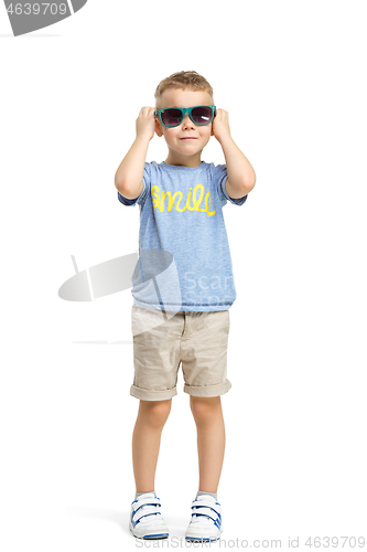 Image of Full length portrait of cute little kid in stylish clothes looking at camera and smiling