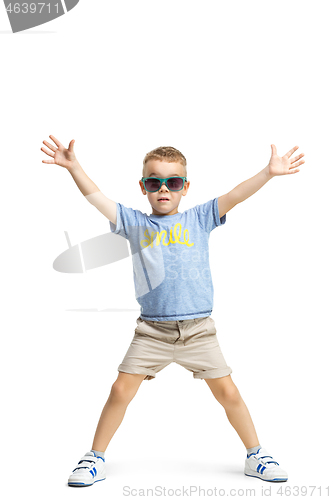 Image of Full length portrait of cute little kid in stylish clothes looking at camera and smiling
