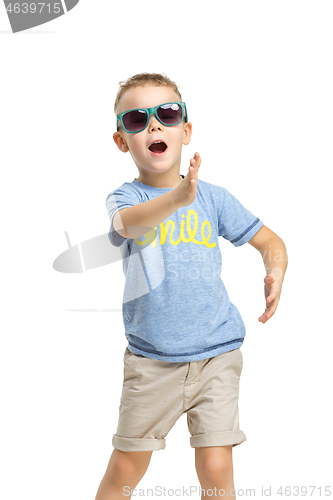 Image of Full length portrait of cute little kid in stylish clothes looking at camera and smiling