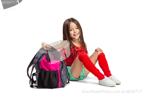 Image of Full length portrait of cute little kid in stylish jeans clothes looking at camera and smiling