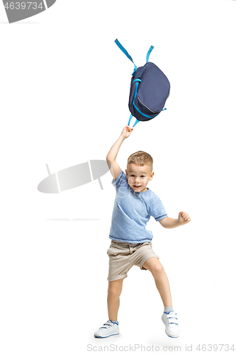 Image of Full length portrait of cute little kid in stylish clothes jumping with bag