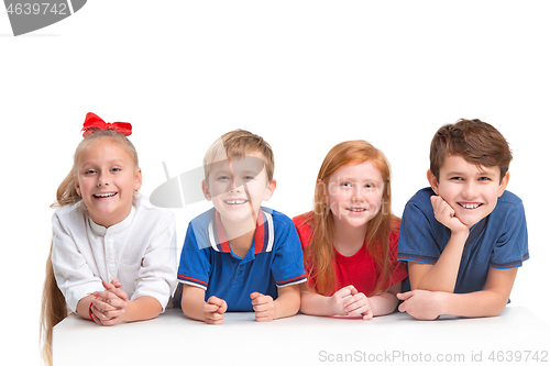 Image of Full length portrait of cute little kids in stylish clothes looking at camera and smiling