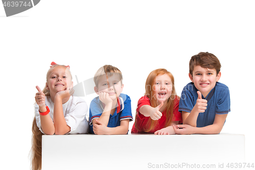 Image of Full length portrait of cute little kids in stylish clothes looking at camera and smiling