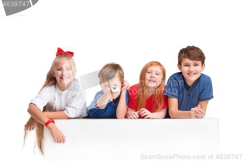 Image of Full length portrait of cute little kids in stylish clothes looking at camera and smiling