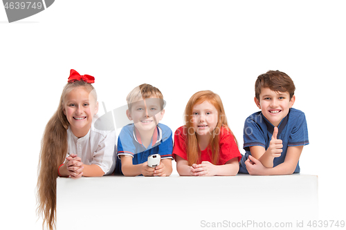 Image of Full length portrait of cute little kids in stylish clothes looking at camera and smiling