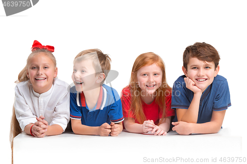 Image of Full length portrait of cute little kids in stylish clothes looking at camera and smiling