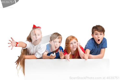 Image of Full length portrait of cute little kids in stylish clothes looking at camera and smiling