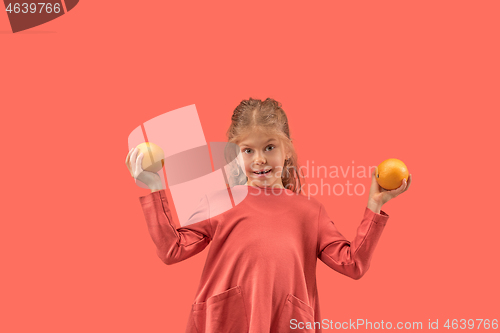 Image of Cute little girl in coral dress with long hair smiling to camera