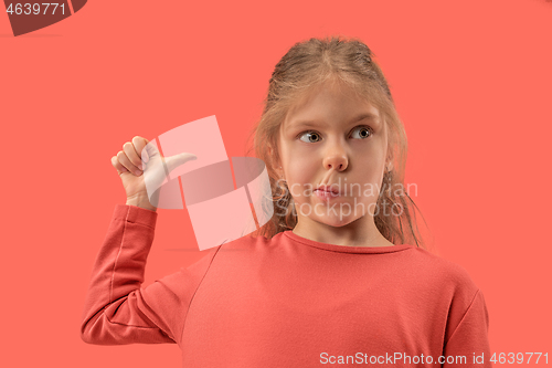 Image of Cute little surprised girl in coral dress with long hair smiling to camera