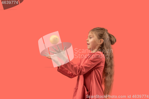 Image of Cute little girl in coral dress with long hair