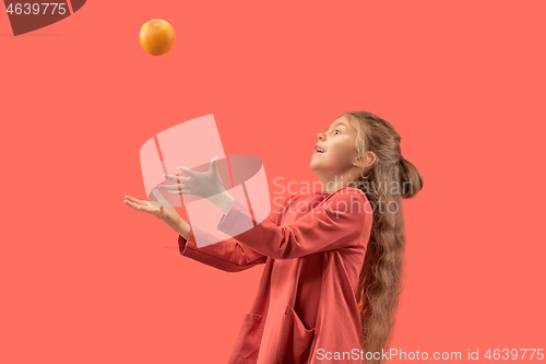 Image of Cute little girl in coral dress with long hair