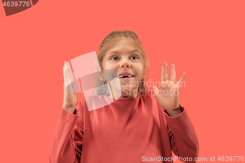 Image of Cute little surprised girl in coral dress with long hair smiling to camera