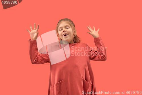 Image of Cute little girl in coral dress with long hair smiling to camera