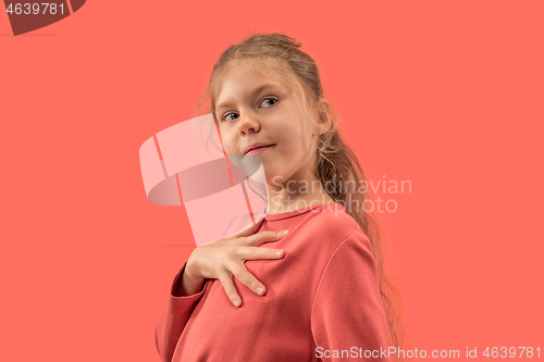 Image of Cute little girl in coral dress with long hair smiling to camera