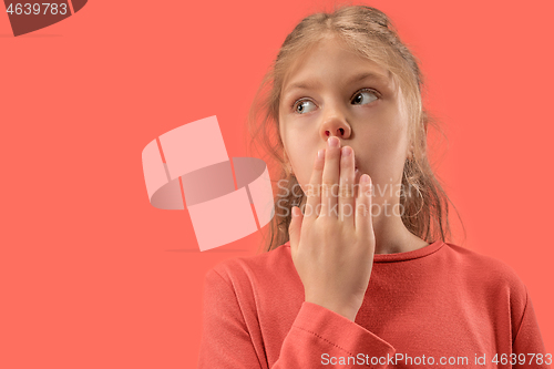 Image of Cute little surprised girl in coral dress with long hair smiling to camera