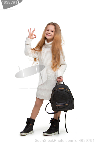 Image of Full length portrait of cute little kid in stylish jeans clothes looking at camera and smiling