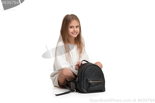 Image of Full length portrait of cute little kid in stylish jeans clothes looking at camera and smiling