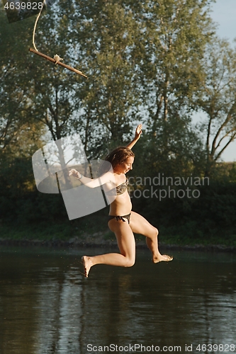 Image of Rope swing river jump