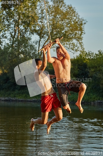 Image of Guys jumping in a river