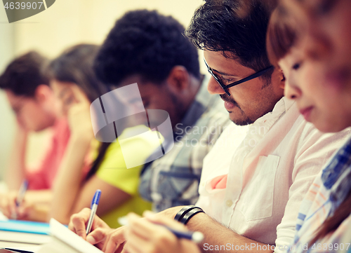 Image of group of international students writing at lecture