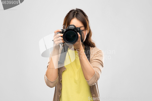 Image of female photographer with digital camera