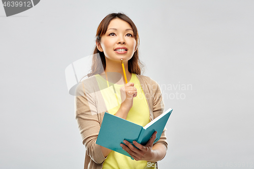 Image of asian student woman with diary and pencil