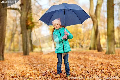 Image of happy little girl with umbrella at autumn park