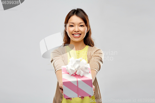 Image of happy african american woman with birthday present