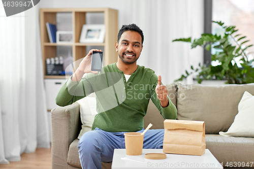 Image of indian man using smartphone for food delivery