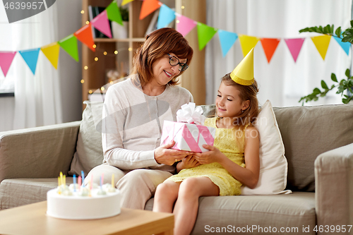 Image of grandmother giving granddaughter birthday gift