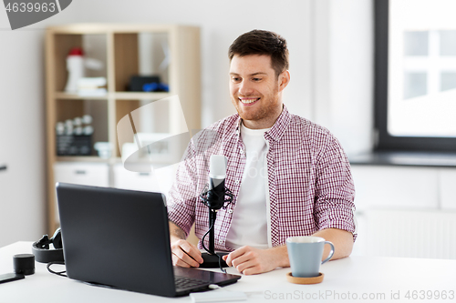 Image of blogger with laptop and microphone audio blogging