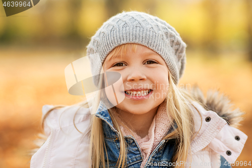 Image of portrait of happy little girl at autumn park