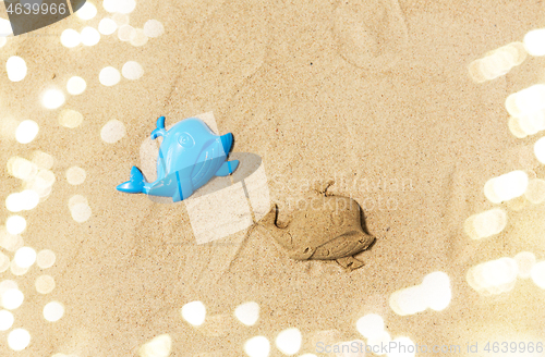 Image of sand shape made by whale mold on summer beach