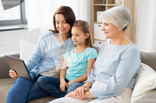 Image of mother, daughter and grandmother with tablet pc