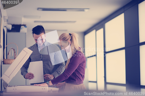 Image of business couple copy documents