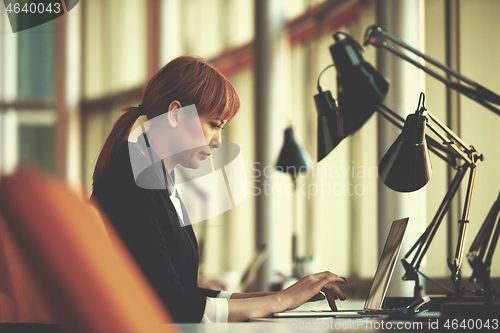 Image of business woman working on computer at office