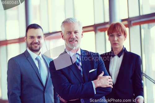 Image of senior business man with his team at office